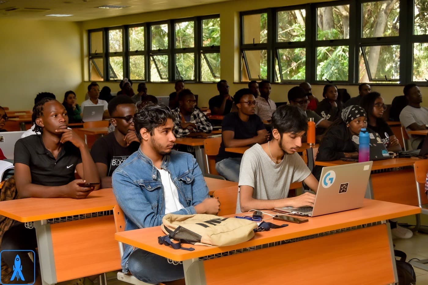 Academy learners at laptops in a classroom